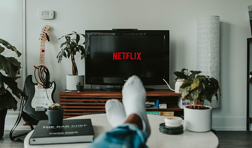 Person Streaming Netflix on TV
